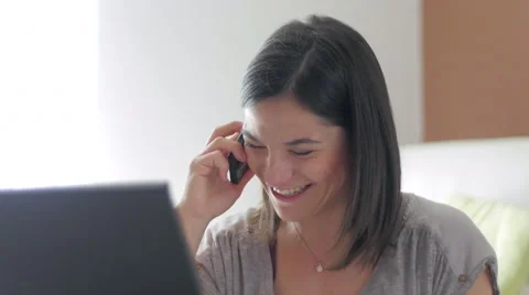 Nice girl browsing internet talking over the phone at home close up 스톡 동영상 49828540