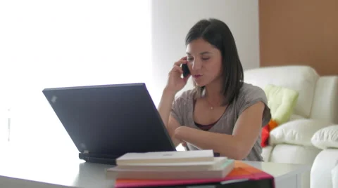 Nice girl browsing internet talking over the phone at home 스톡 동영상 49833297