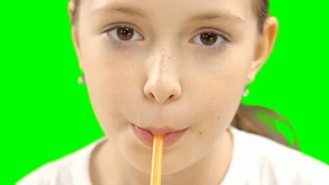 Nice girl drinking through a straw drink. Green screen Stock Footage 87387403