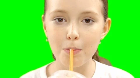 Nice girl drinking through a straw drink. Green screen Stock Footage 87387440