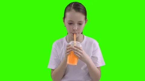 Nice girl drinking through a straw drink. Green screen Stock Footage 87389106