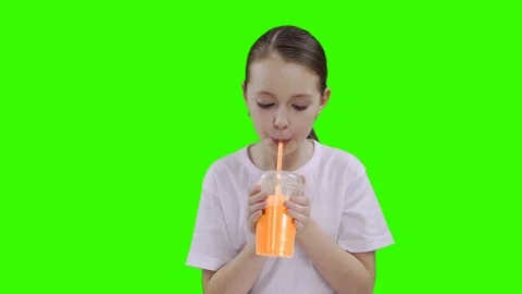 Nice girl drinking through a straw drink. Green screen Stock Footage 87389168