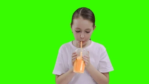 Nice girl drinking through a straw drink. Green screen Stock Footage 87389209