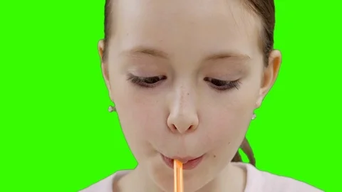 Nice girl drinking through a straw drink. Green screen Stock Footage 87389248