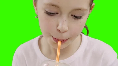 Nice girl drinking through a straw drink. Green screen Stock Footage 87389293