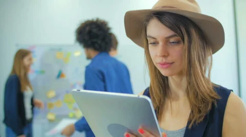 The nice girl in a hat thumbed through news, and then smiles Stock Footage 60787495