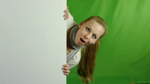 Nice girl peeking from behind blank sign billboard. no.02 Stock Footage 32640468