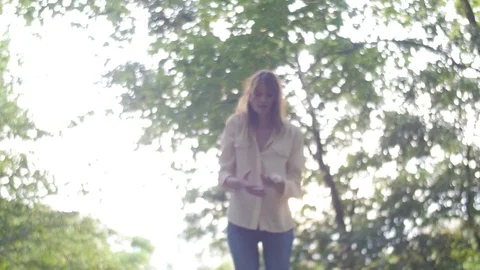 Nice girl playing in park in spring Stock Footage 73499673