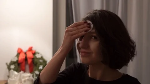 Nice girl remove makeup from her face Stock Footage 100997863