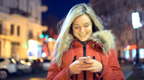 Nice girl using app on smart phone at night. Stock Footage 60414722