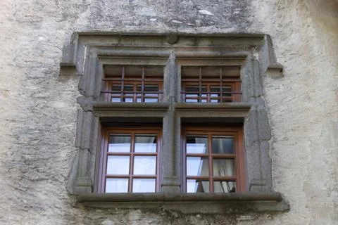 Nice glimpse of a window in an ancient castle in an alpine village Stock Photos