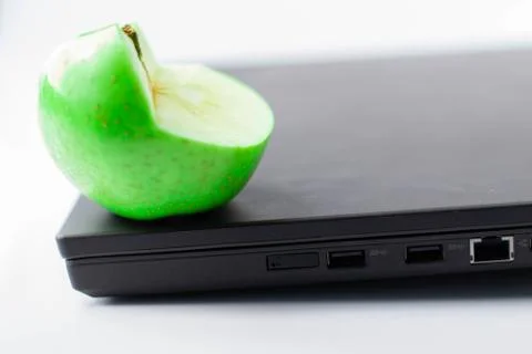 Nice green apple on a computer Stock Photos
