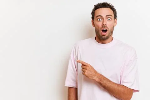Nice guy with beard standing on white background in white T-shirt, posing very Stock Photos