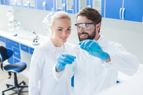 Nice happy scientists looking at the test tubes Stock Photos