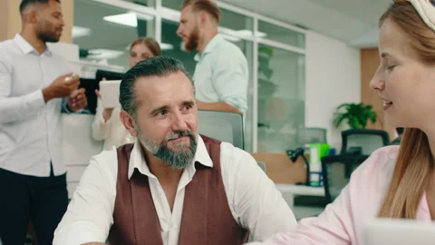 A nice intelligent man is talking to his co-worker about their work ethic while Stock Footage 166908421