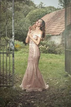 Nice lady in luxury apparel posing for magic portraits outdoor 库存照片