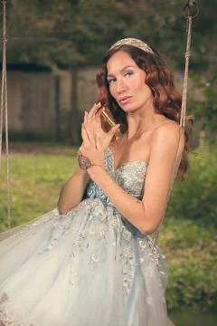 Nice lady in luxury apparel posing for magic portraits outdoor 库存照片