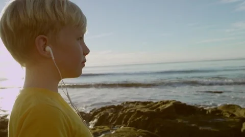 Nice little guy on a seashore with his smartphone and a credit card Stock-Footage 75745581