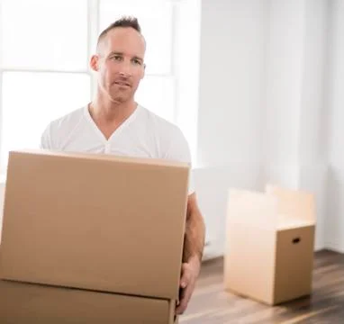 A nice man with boxes at home 写真素材