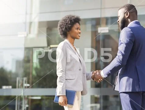 Nice to meet you. Two african business people introducing outdoors Stock Photos
