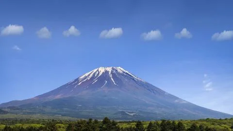 Nice mountain with align clouds with nice blue and green tree Stock Photos
