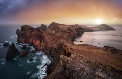 Nice ocean landscape - Dramatic sunrise over colorful cliffs of Ponta de Sao  Stock Photos