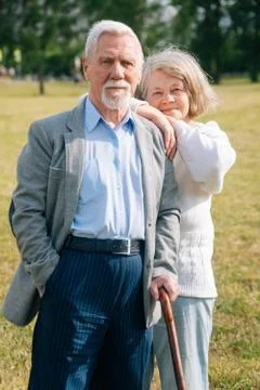 A nice old couple of gray-haired people in the background of the forest. Gran Stock Photos