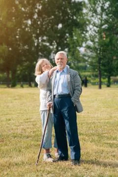 A nice old couple of gray-haired people in the background of the forest. Gran Stock Photos