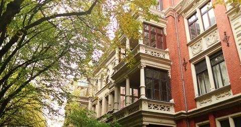 Nice old style red building in residential area with trees durring fall season Stock Footage 230491125