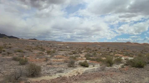 Nice pan of desert scenery with cloudy blue sky and dry ground Video stock 85220288