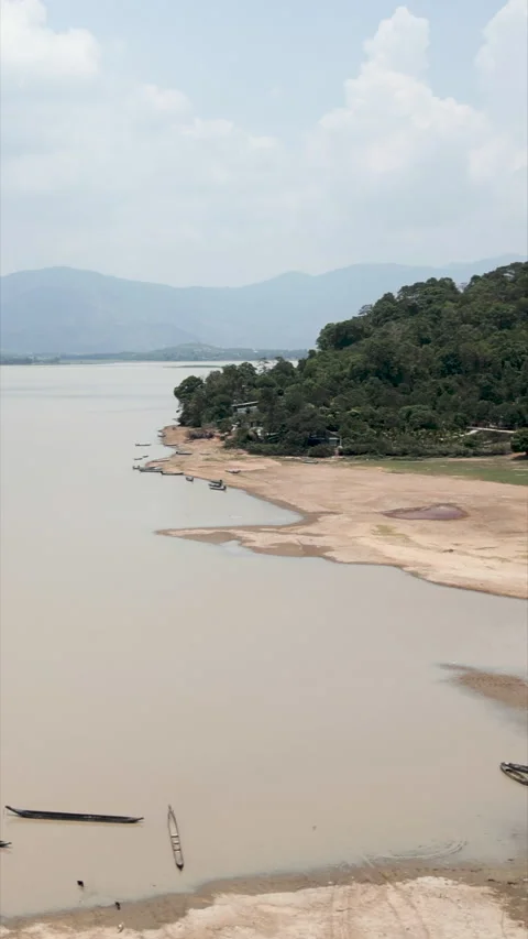 Nice panoramic drone view over the big lake near the canoes and the forest Stock Footage 278244275