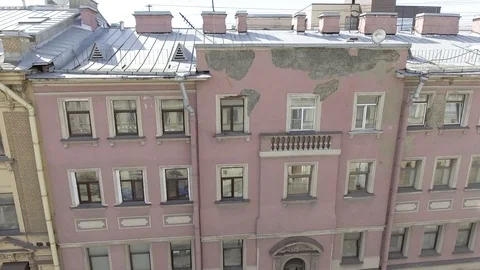 Nice panoramic view of pink house facade with windows, rooftops, gutter pipes. Stock Footage 107117643