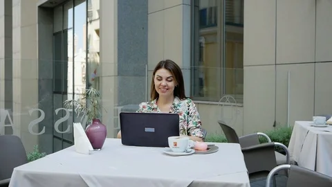Nice place. Smiling lady looking at notebook computer while sitting at table 스톡 동영상 102391521