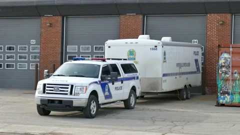 Nice police pick up parked in front of garage Stock Footage 139664107
