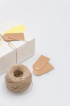 Nice present packed in white paper with small yellow stars on background Stock Photos