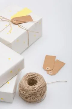 Nice present packed in white paper with small yellow stars on white backgroun Stock Photos