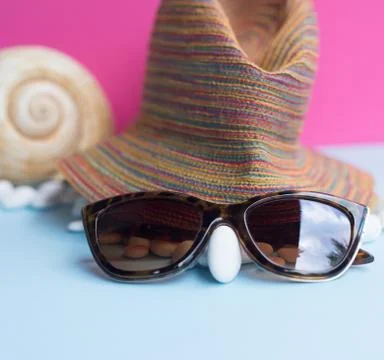 Nice representation of a woman's face with a hat, sunglasses and a white pebb Stock Photos