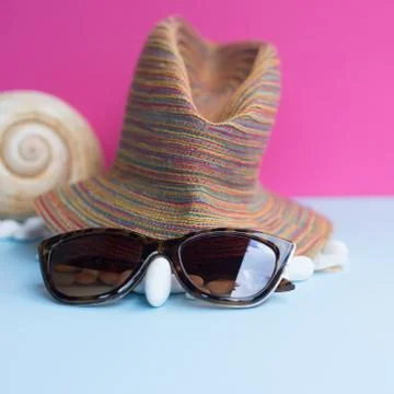 Nice representation of a woman's face with a hat, sunglasses and a white pebb Stock Photos