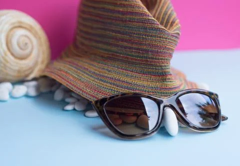 Nice representation of a woman's face with a hat, sunglasses and a white pebb Stock Photos