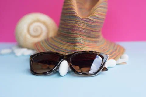 Nice representation of a woman's face with a hat, sunglasses and a white pebb Stock Photos