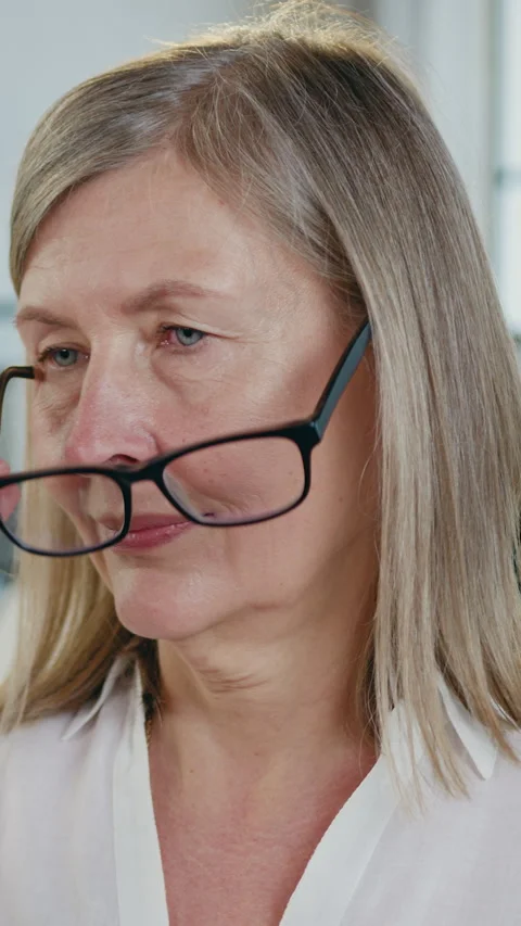 Nice satisfied successful experienced 45-aged female ceo in eyeglasses posing on Stock Footage 329441401