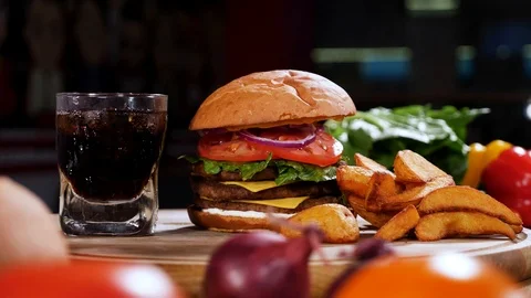Nice set of fast food on a table, burger, French fries, coke 4k Stock Footage 94263844