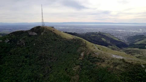 A nice side-angle drone shot at Bowendale Park, with the city of Christchurch Stock Footage 345339095