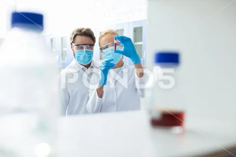 Nice smart scientists working in the medical lab Stock Photos