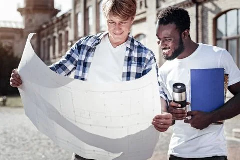 Nice smart students studying the blueprint Fotos de archivo