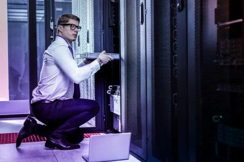 Nice smart young man stealing the database Stock Photos