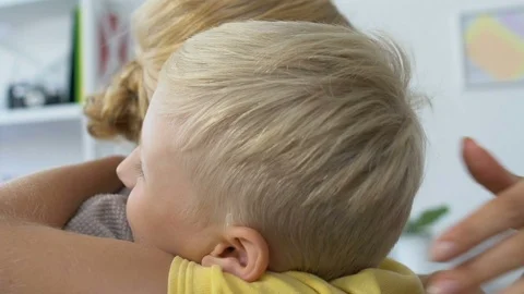 Nice smiling boy hugging mother, love and care, warm family relationship 動画素材 119036256