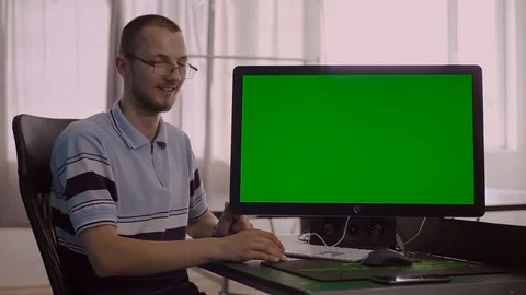 Nice student sitting at table near computer. Portrait of cute smart young man Stock Footage 93164095