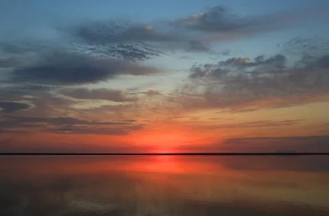 Nice sunset over water surface Stock Photos