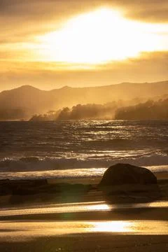 Nice sunset sunlight in a windy day over the waves in Costa Brava of Spain Stock Photos